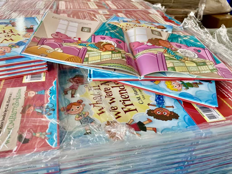 Stack of children's books with colorful covers on a table.